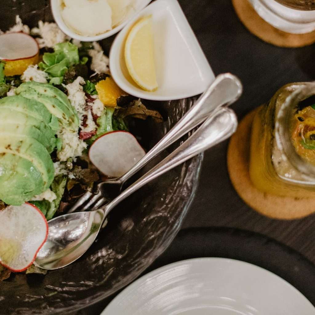 tasty salad and smoothie on table