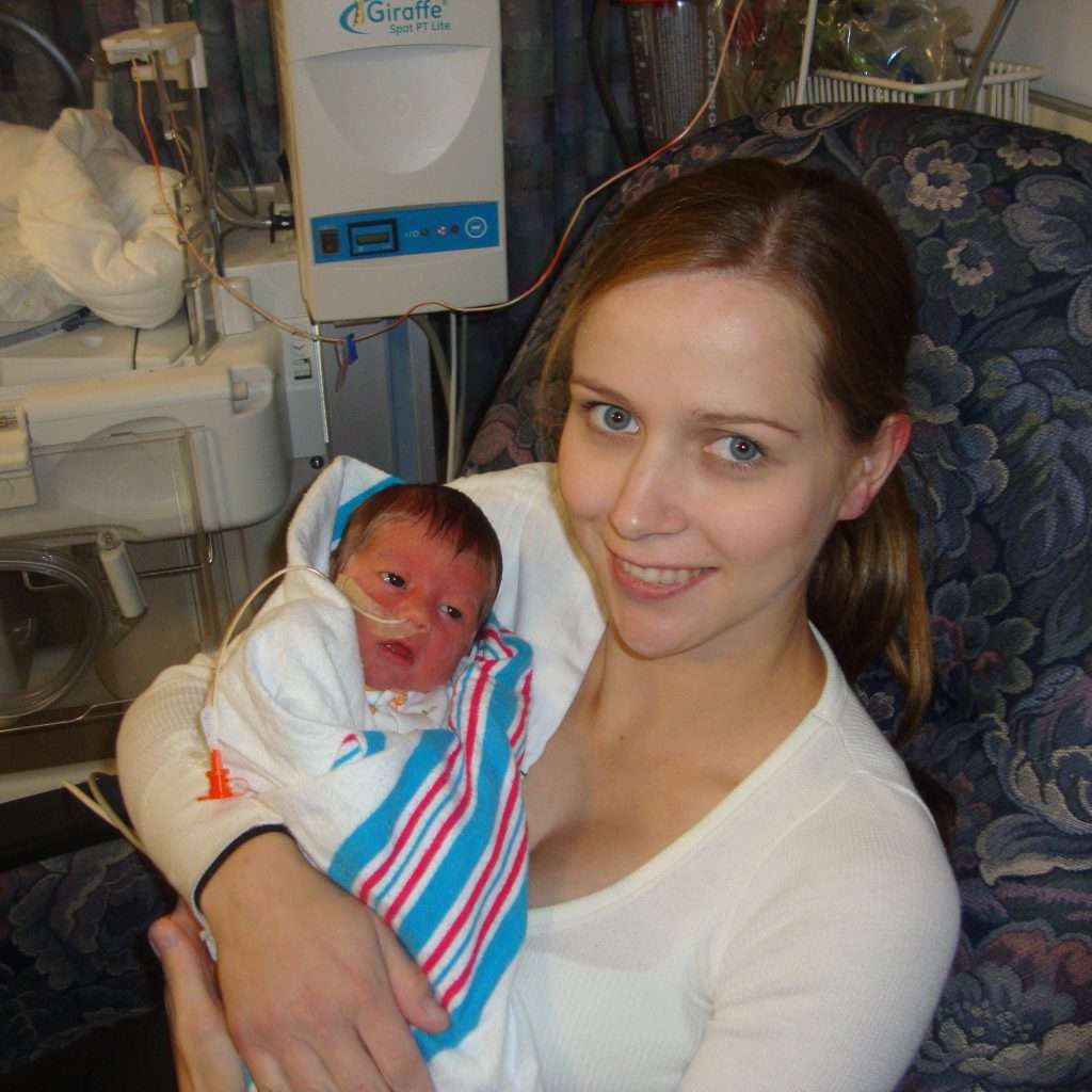 Woman with a spinal cord injury holding her newborn baby